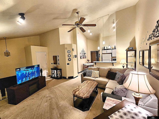 living room with high vaulted ceiling, carpet, and a ceiling fan