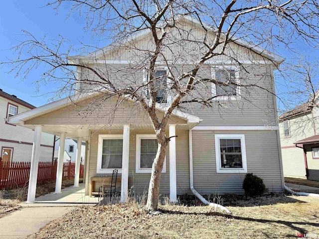 view of front of house featuring a porch and fence