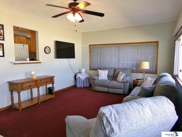 living room featuring baseboards, carpet floors, and ceiling fan