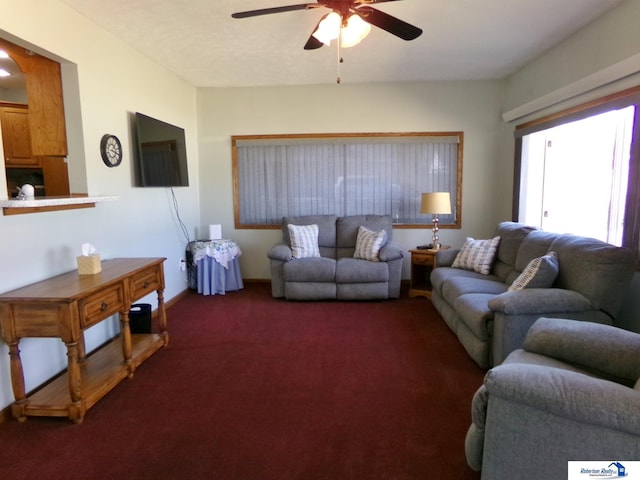 living room with dark carpet and a ceiling fan