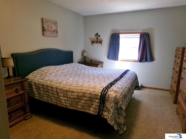 bedroom with baseboards and carpet floors