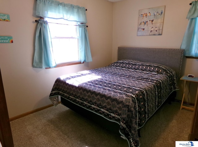 bedroom featuring baseboards and carpet floors