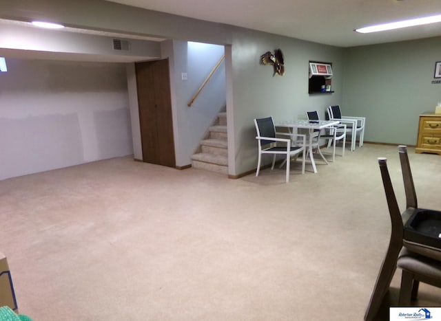 dining room with carpet flooring, stairway, and visible vents