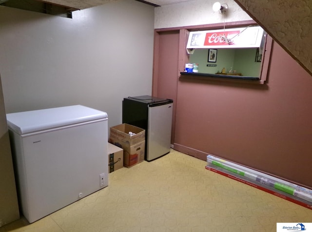 laundry area with baseboards