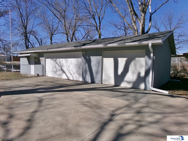 detached garage featuring fence