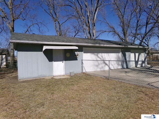 view of outbuilding featuring a garage and fence