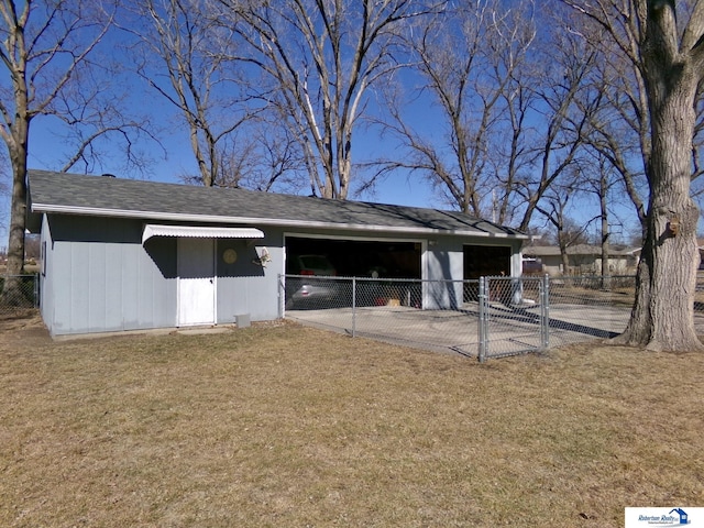 view of outdoor structure with a carport and fence