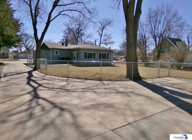 view of front of house featuring concrete driveway and a fenced front yard