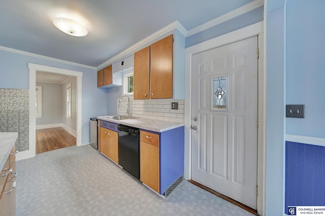 kitchen with a sink, brown cabinets, dishwasher, and crown molding