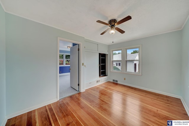 unfurnished bedroom with visible vents, multiple windows, and light wood-style floors