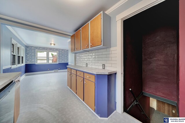 kitchen featuring visible vents, ornamental molding, light countertops, and stainless steel dishwasher