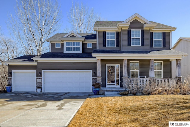 view of front facade with a garage, a front yard, covered porch, and concrete driveway