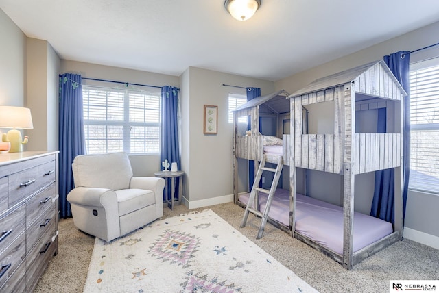 bedroom with multiple windows and baseboards