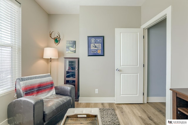 living area featuring wood finished floors and baseboards