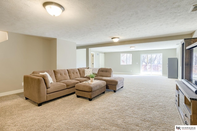 carpeted living area featuring visible vents, baseboards, and a textured ceiling