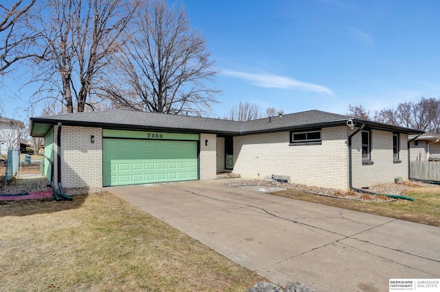 single story home featuring concrete driveway, an attached garage, brick siding, and a front lawn