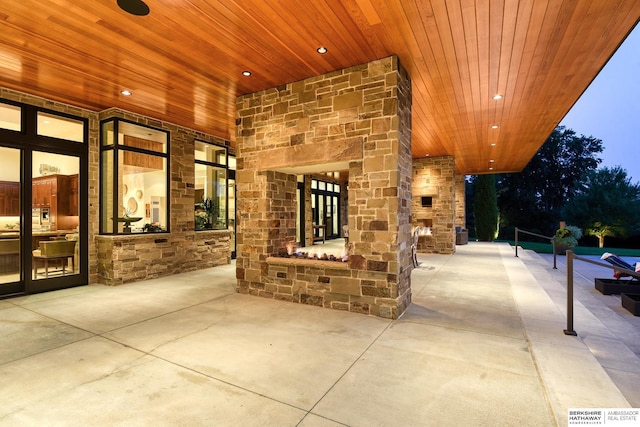 view of patio with an outdoor stone fireplace