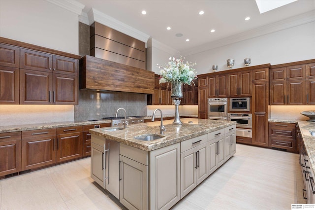 kitchen with crown molding, custom range hood, decorative backsplash, a skylight, and a sink