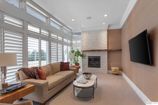 carpeted living room featuring baseboards, visible vents, a fireplace, recessed lighting, and crown molding