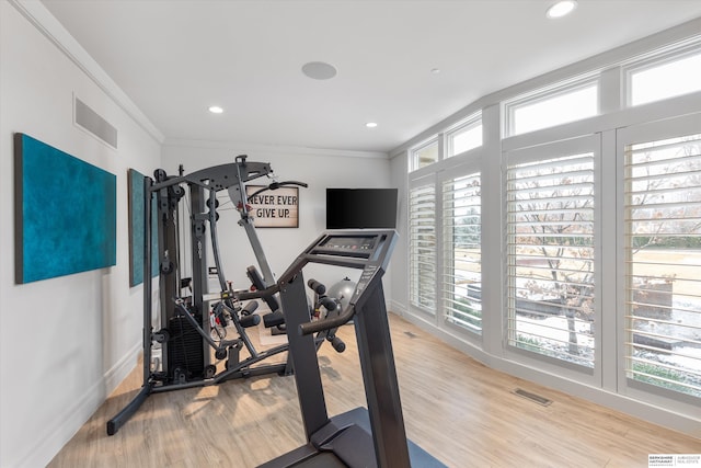 exercise area with recessed lighting, visible vents, wood finished floors, and ornamental molding