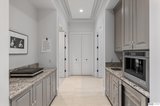 kitchen with appliances with stainless steel finishes, gray cabinetry, and a sink