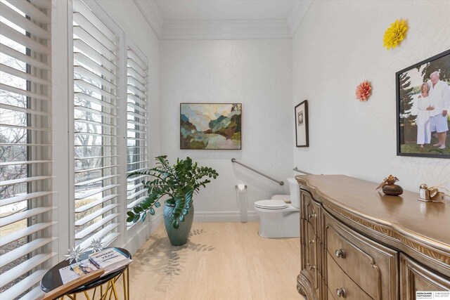 bathroom with toilet, baseboards, and ornamental molding