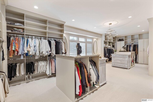 spacious closet featuring light carpet