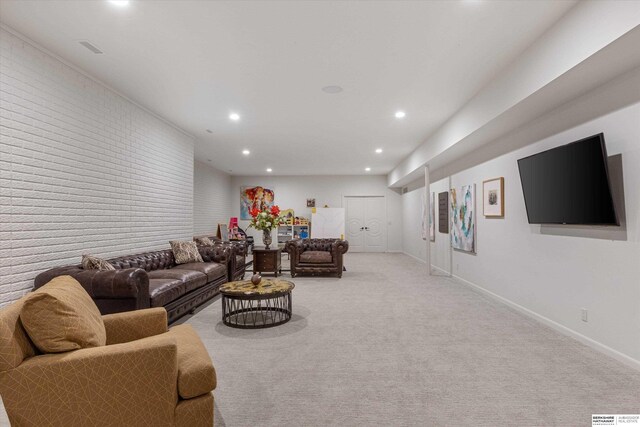 living area with visible vents, baseboards, brick wall, recessed lighting, and light carpet