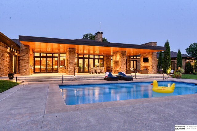 pool featuring french doors and a patio