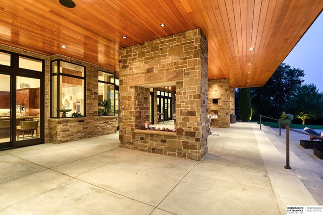 view of patio featuring an outdoor stone fireplace