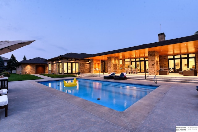 outdoor pool with an outdoor living space and a patio area