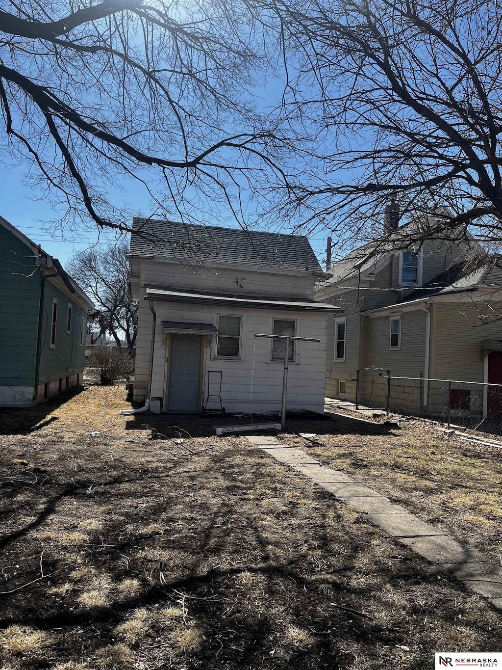 rear view of property with fence