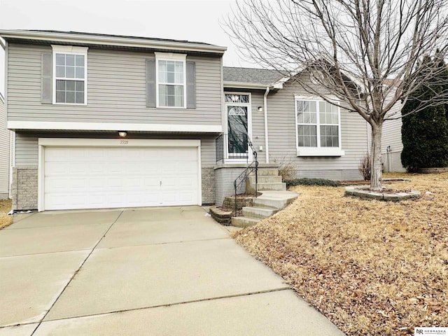 tri-level home with driveway and a garage