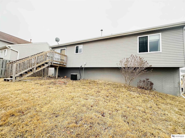 back of property featuring a yard, central AC, stairs, and a deck