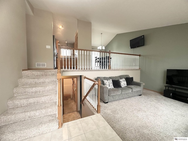 carpeted living area featuring visible vents, high vaulted ceiling, stairs, and tile patterned flooring