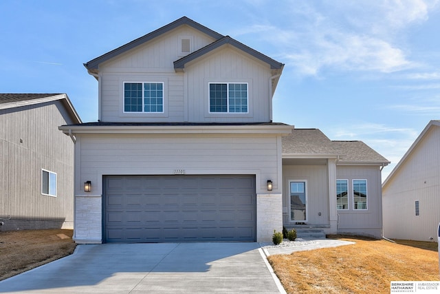 view of front of property with board and batten siding, stone siding, a garage, and driveway