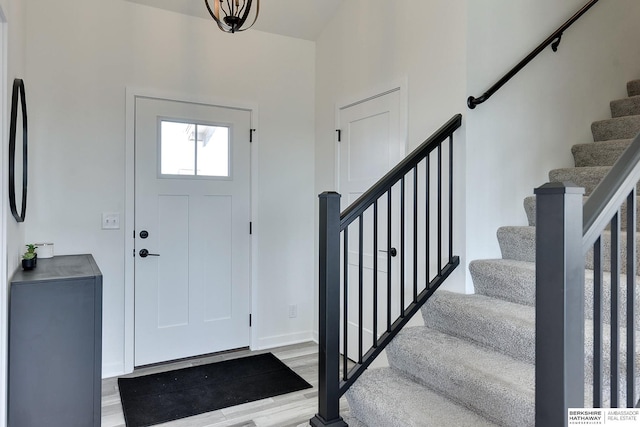 entrance foyer with stairway and wood finished floors