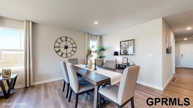 dining space with recessed lighting, wood finished floors, and baseboards