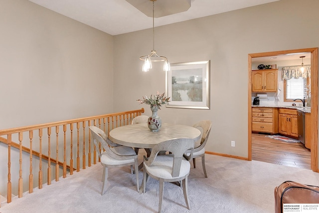 dining room with baseboards and light carpet