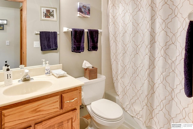 full bathroom featuring shower / bathtub combination with curtain, toilet, and vanity