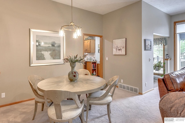 dining area with visible vents, baseboards, and light colored carpet