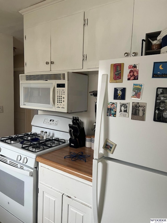 kitchen with white cabinetry and white appliances