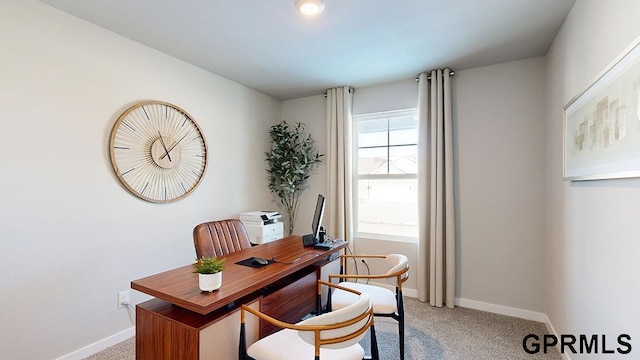 home office featuring baseboards and light carpet