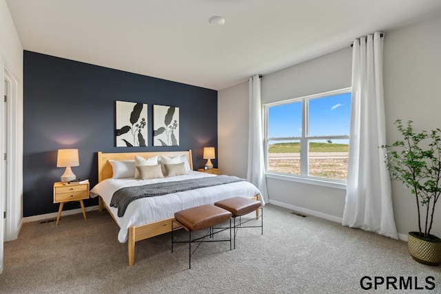 carpeted bedroom with visible vents and baseboards