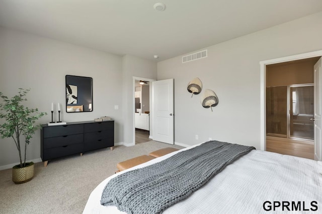 bedroom featuring light colored carpet, visible vents, and baseboards