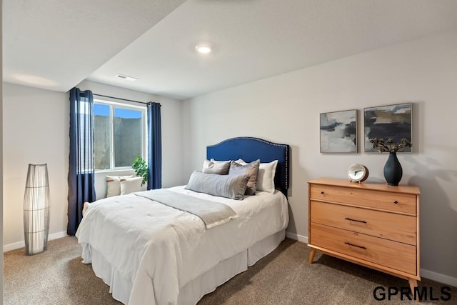 bedroom featuring baseboards, visible vents, and dark colored carpet