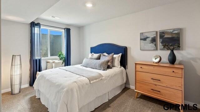 bedroom featuring visible vents, dark colored carpet, and baseboards