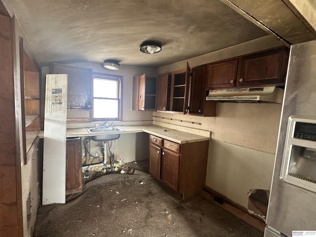 kitchen with under cabinet range hood, dark brown cabinets, light countertops, and a sink