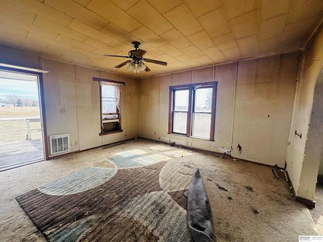 spare room with a wealth of natural light and a ceiling fan