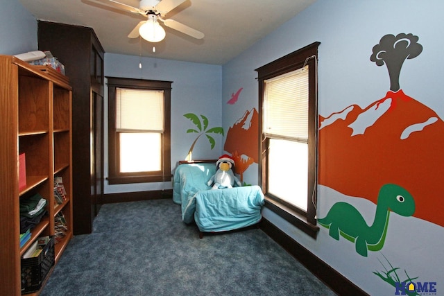 interior space featuring baseboards, carpet floors, and a ceiling fan